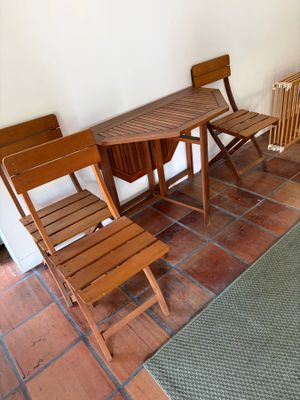 chairs and a table in a room with a rug on the floor