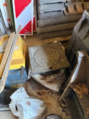 a pile of junk on the floor of a garage