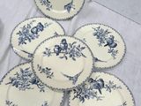six blue and white plates with birds and flowers on them on a table