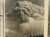 a black and white photo of a large plume of smoke