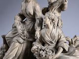 sculpture of a group of women with a guitar on a table