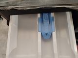 a drawer that has a blue plastic object in it