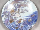 a plate with a picture of a tree and birds on it