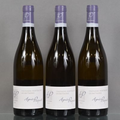 three bottles of wine sitting on top of a table next to each other