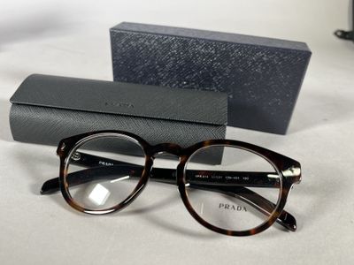 glasses and a case on a table with a pair of glasses on it