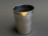 a metal cup that is sitting on a table