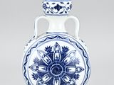 blue and white vase with a flower design on the bottom