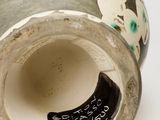 a close up of a vase with a tag on it