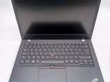 the laptop is open on a white surface with a black keyboard