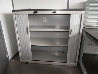 a metal cabinet in the middle of a kitchen