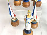 several figurines of soldiers are on display in a glass case