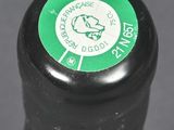 a close up of a bottle of wine with a green label