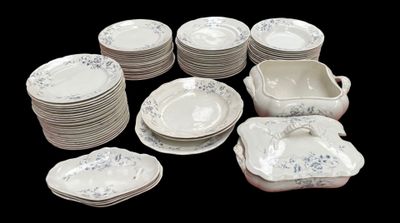 a lot of plates and bowls that are sitting on a table