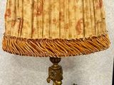 a lamp that is sitting on a table with a lamp shade on it