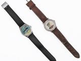 an image of a couple of watches sitting next to each other