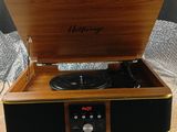 an image of a record player sitting on top of a wooden table