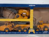 toy construction vehicles are in a box on a white surface