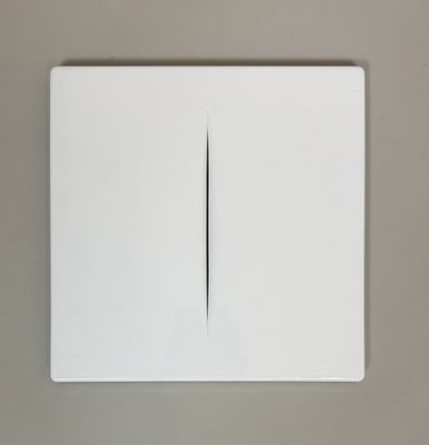 an overhead view of a white light switch on a gray wall