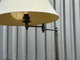 a lamp that is sitting on a pole in front of a building