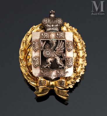 an image of a gold and silver broochle with a crown on top of it