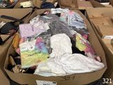 a cardboard box filled with clothing and other items