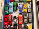 a lot of toy cars in a box on a table