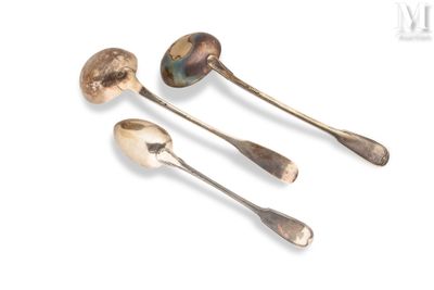 three silver spoons and a spoon rest on a white surface