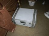 a white box sitting on the floor next to a toilet