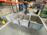 three bins in the middle of a warehouse with pallets