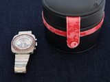 a watch that is sitting next to a watch case