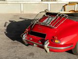 a red car with a surfboard on top of it