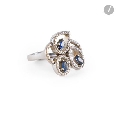 an image of a diamond and sapphire ring on a white background