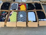 many boxes of clothes that are sitting on the ground