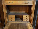 a wooden desk with a drawer underneath it in a room