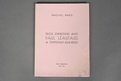 a pink book on a table with a black background