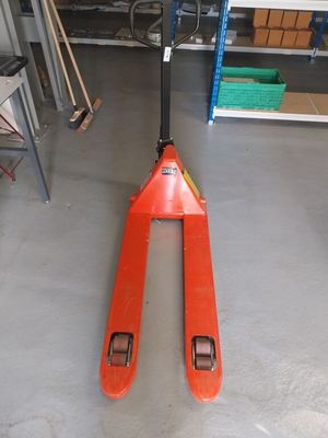 a fork lifter sitting in a garage on the floor