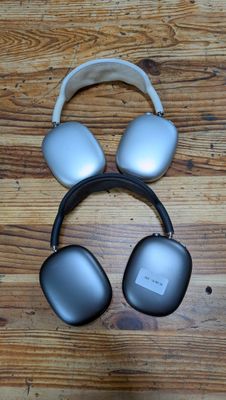 headphones are laying on a wooden surface on a table