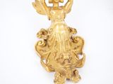 brass figurine of a woman with a bird on her head