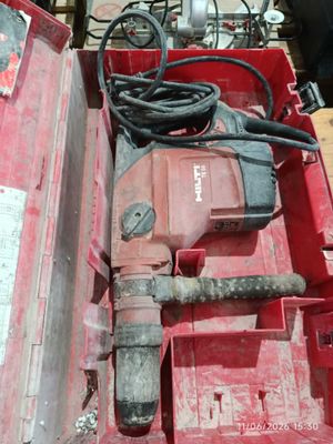 a red tool box with a hammer and other tools in it