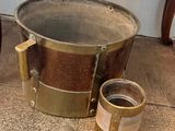 a bucket and a can on the floor next to a chair