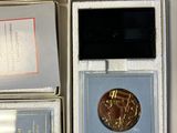 several boxes of coins are stacked on top of each other on a table