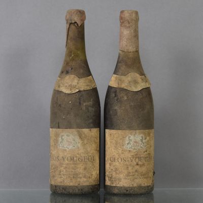two bottles of wine sitting on top of a table next to each other