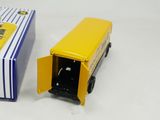 a yellow toy truck with a door open next to a box
