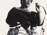 an old black and white photo of a woman holding a trumpet