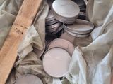 a pile of coins and a wooden ruler in a box
