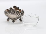 a small glass bowl and a small glass bowl on a white surface