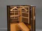 a suitcase that is open and has a coat hanger in it