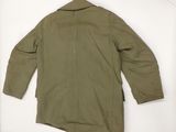 the back of a green jacket with a hood on a hanger