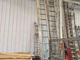 many ladders that are sitting in a room