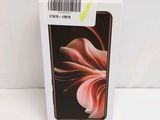 the box is open and the phone is in it ' s packaging
